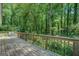 Spacious wooden deck overlooking a tranquil backyard with mature trees and lush greenery at 357 Oak Hill Rd, Covington, GA 30016