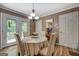 Charming dining area with a round table, decorative chandelier, and view of the outdoor deck at 357 Oak Hill Rd, Covington, GA 30016