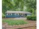 Lovely single-story home with mature landscaping, gravel driveway, and inviting front entrance at 357 Oak Hill Rd, Covington, GA 30016