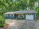 Charming home featuring a well-maintained exterior and a one-car garage at 357 Oak Hill Rd, Covington, GA 30016