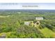 An aerial view shows the home set amongst mature trees in Locust Grove, GA at 74 Price W Dr, Locust Grove, GA 30248