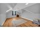 Finished attic features light gray walls, wood floors, skylights, and sloped ceilings at 74 Price W Dr, Locust Grove, GA 30248