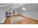 Finished attic features light gray walls, wood floors, and sloped ceilings at 74 Price W Dr, Locust Grove, GA 30248