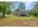 Large backyard with a storage shed, fencing, and a covered patio on the main house at 74 Price W Dr, Locust Grove, GA 30248