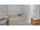 Large bathtub area has tiled walls and space for storage at 74 Price W Dr, Locust Grove, GA 30248