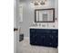 Updated bathroom features a vanity, tile floors, a large mirror, and a sink at 74 Price W Dr, Locust Grove, GA 30248