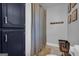 Bright bathroom features a toilet, tiled floors, and navy blue storage cabinets at 74 Price W Dr, Locust Grove, GA 30248