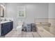 Bathroom features a single sink vanity, toilet, and tub with shower at 74 Price W Dr, Locust Grove, GA 30248