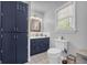 Bathroom features built in cabinets, a window and sink with a framed mirror at 74 Price W Dr, Locust Grove, GA 30248