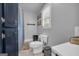 Bright bathroom features a toilet, tiled floors, and a navy blue storage cabinet at 74 Price W Dr, Locust Grove, GA 30248