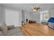 Spacious bonus room features light gray walls, wood floors and a ceiling fan for added comfort at 74 Price W Dr, Locust Grove, GA 30248