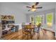 Breakfast area featuring a round table, ceiling fan, and three-pane windows overlooking a green yard at 74 Price W Dr, Locust Grove, GA 30248