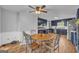 Open floor plan kitchen and breakfast area with navy cabinets and wood-look tile flooring at 74 Price W Dr, Locust Grove, GA 30248