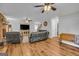 Spacious living room featuring hardwood floors, a brick fireplace, and ample seating at 74 Price W Dr, Locust Grove, GA 30248
