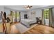 Serene main bedroom featuring a large window and hardwood flooring at 74 Price W Dr, Locust Grove, GA 30248