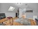 Bright home office space features light gray walls, wood floors and a skylight for natural lighting at 74 Price W Dr, Locust Grove, GA 30248
