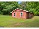 Exterior view of red shed with two visible windows and lots of surrounding greenery at 74 Price W Dr, Locust Grove, GA 30248