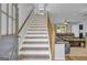 Elegant staircase with wooden handrail and bright, neutral decor at 74 Price W Dr, Locust Grove, GA 30248