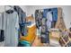 Storage room with wood cabinets, utility sink, and clothes hanging from racks at 74 Price W Dr, Locust Grove, GA 30248