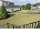 Spacious backyard with a well-maintained lawn and black metal fencing, offering a secure outdoor space at 312 Archway Ln, Peachtree City, GA 30269