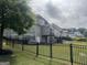 Expansive backyard with a black iron fence, lush lawn, and a view of the home's rear elevation at 312 Archway Ln, Peachtree City, GA 30269