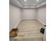 A finished basement with recessed lighting, white trim, and wood look flooring at 312 Archway Ln, Peachtree City, GA 30269