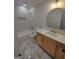 Bathroom featuring marble flooring, white tiled shower and walls, and light wood cabinets at 312 Archway Ln, Peachtree City, GA 30269