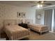 Charming bedroom with floral wallpaper and two twin beds, creating a warm and inviting space at 312 Archway Ln, Peachtree City, GA 30269