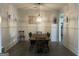 Formal dining room with a farmhouse table, elegant lighting and hardwood floors at 312 Archway Ln, Peachtree City, GA 30269