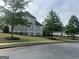 Side view of a charming two-story home with well-manicured lawn and tree-lined street at 312 Archway Ln, Peachtree City, GA 30269