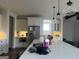 Bright kitchen features a large center island with quartz countertop, stainless steel appliances, and pendant lighting at 312 Archway Ln, Peachtree City, GA 30269
