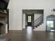 Open floor plan with a staircase, brick fireplace, and wood floors at 312 Archway Ln, Peachtree City, GA 30269