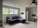 Cozy living room with a comfortable sofa, ceiling fan, and wall-mounted televisions at 312 Archway Ln, Peachtree City, GA 30269