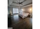 Serene main bedroom featuring a tray ceiling, hardwood floors, and bright natural light at 312 Archway Ln, Peachtree City, GA 30269