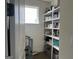 Walk-in pantry offers ample shelving space for organized storage, plus a window for natural light at 312 Archway Ln, Peachtree City, GA 30269