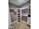 Walk-in closet with custom shelves and hanging racks, provides plenty of storage space at 312 Archway Ln, Peachtree City, GA 30269