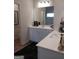 Bright bathroom with dual sinks, white cabinets, and modern fixtures at 613 Elsa Lane # 77, Mcdonough, GA 30252