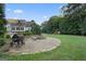 Backyard with a fire pit, play set, patio, BBQ grill, and house views at 885 Kelleytown Rd, Mcdonough, GA 30252