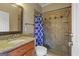 Bathroom features a granite countertop sink and a tile shower with a decorative blue curtain at 885 Kelleytown Rd, Mcdonough, GA 30252