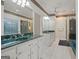 Well-lit bathroom showcasing dual sinks with green marble countertops and white cabinets, plus shower and tub at 885 Kelleytown Rd, Mcdonough, GA 30252