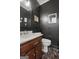Cozy powder room featuring dark walls, marble floors, and classic fixtures at 885 Kelleytown Rd, Mcdonough, GA 30252