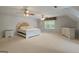 Spacious bedroom with carpet, ceiling fans, large window, and neutral color scheme at 885 Kelleytown Rd, Mcdonough, GA 30252