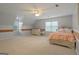 Cozy bedroom featuring neutral walls, carpet, ample natural light, and light-colored furnishings at 885 Kelleytown Rd, Mcdonough, GA 30252