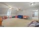 Spacious bonus room featuring neutral colors, carpet flooring, ceiling fans, and plenty of space for activities at 885 Kelleytown Rd, Mcdonough, GA 30252