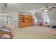 Large bonus room offering ample space, ceiling fans, built in storage, carpet, and neutral paint palette at 885 Kelleytown Rd, Mcdonough, GA 30252