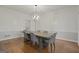 The dining room has a gray wood table with six gray chairs and a decorative light fixture at 885 Kelleytown Rd, Mcdonough, GA 30252