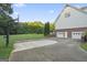 Spacious driveway with a basketball hoop leading to a two-car garage and a well-maintained lawn at 885 Kelleytown Rd, Mcdonough, GA 30252