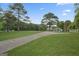 Expansive lot featuring a well-maintained driveway, lush lawn, and classic home surrounded by trees at 885 Kelleytown Rd, Mcdonough, GA 30252