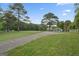 Expansive lot featuring a well-maintained driveway, lush lawn, and classic home surrounded by trees at 885 Kelleytown Rd, Mcdonough, GA 30252