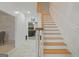 Entryway featuring staircase with wood railing and white spindles, leading into the living room at 885 Kelleytown Rd, Mcdonough, GA 30252